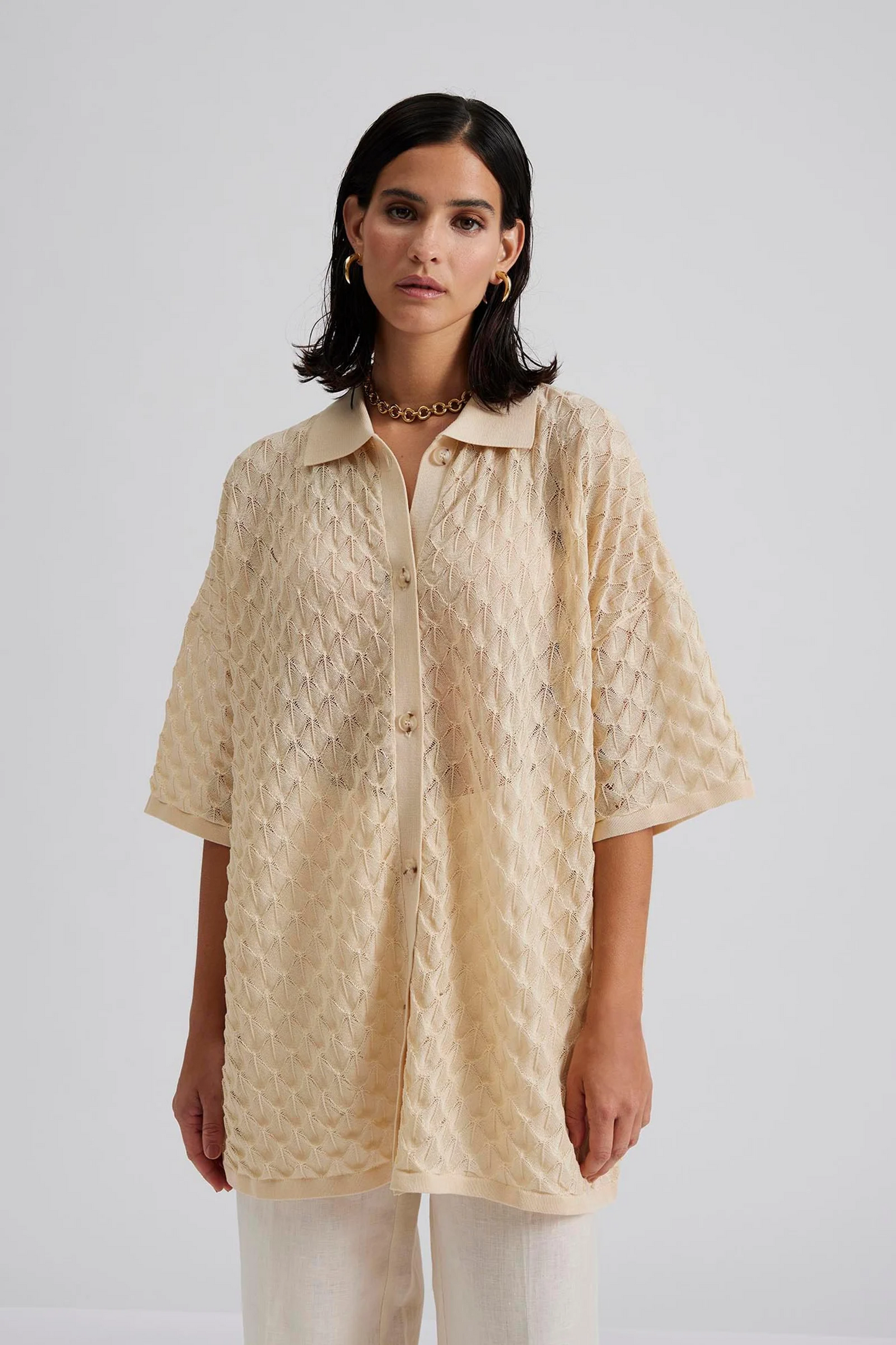 Close up 1 Malina Short sleeve crocheted shirt with buttons in the front. The perfect addition to your luxury designer resort wear wardrobe.