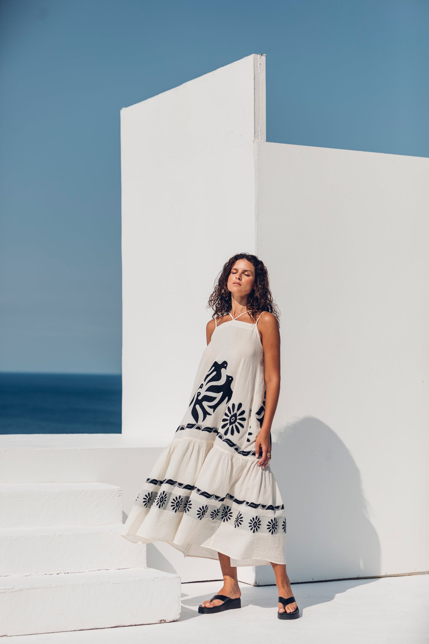 Side facing **PRE-ORDER 1st APRIL** Nema Kalia Embroidered Ecru Maxi Dress. The perfect addition to your luxury designer resort wear wardrobe.