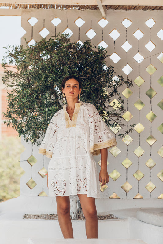 Front facing **PRE-ORDER 1st APRIL** Nema Elle Broderie White Cut Out Mini Dress with gold detail.  The perfection addition to your luxury designer resort wear wardrobe.