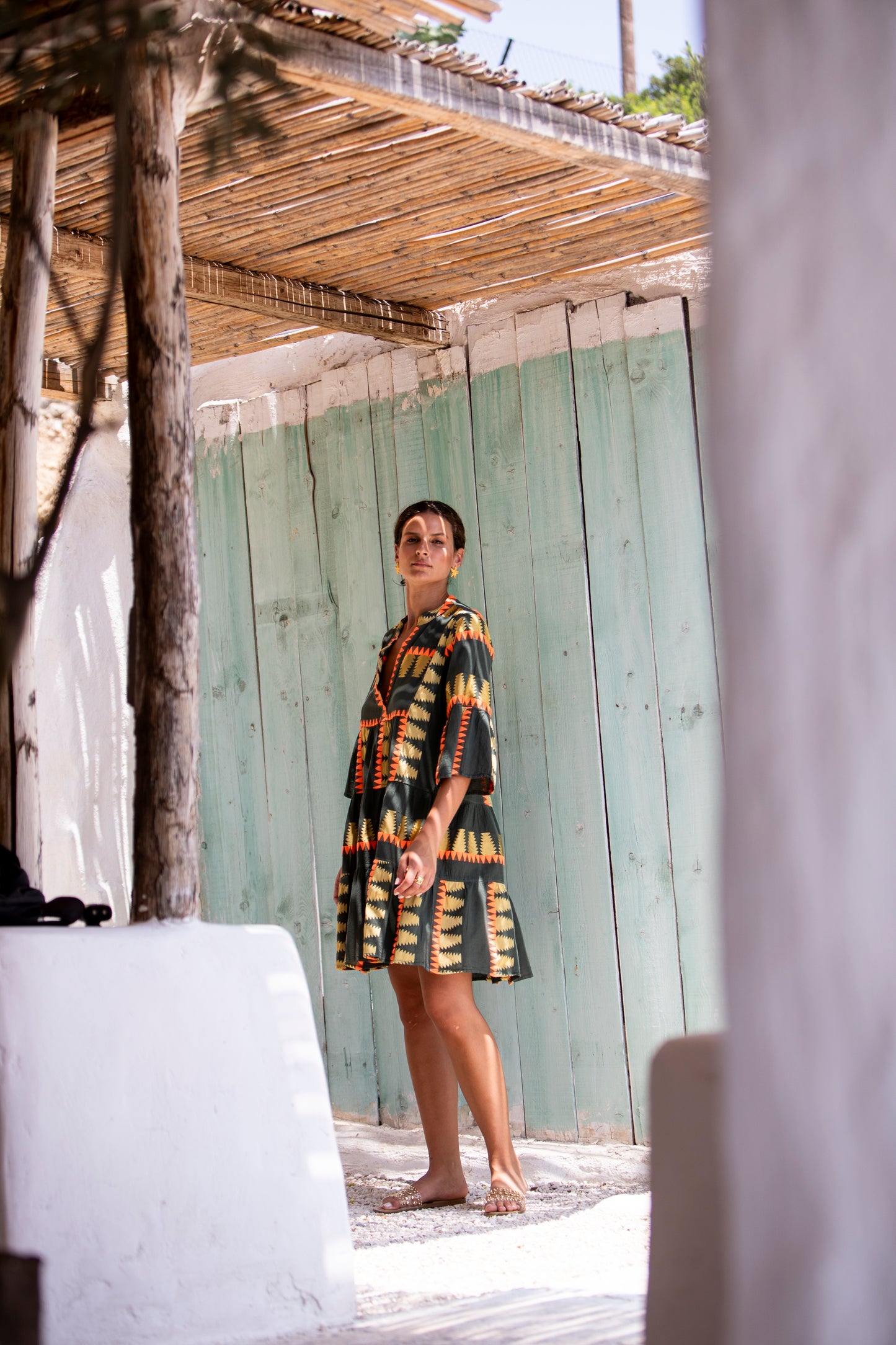 Side facing 3 **PRE-ORDER 1st APRIL** Nema Zadie Embroidered Aztec Khaki Dress. The perfect addition to your luxury designer resort wear wardrobe. Made in Greece.