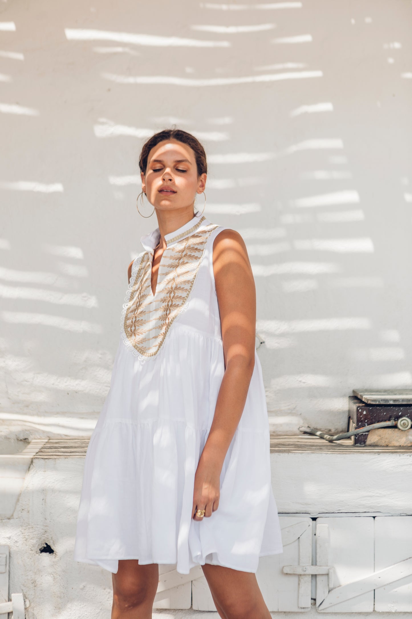 Side facing **PRE-ORDER 1st APRIL** Nema Dafne White Sleeveless Dress With Gold Embroidery. The perfection addition to your luxury designer resort wear wardrobe.