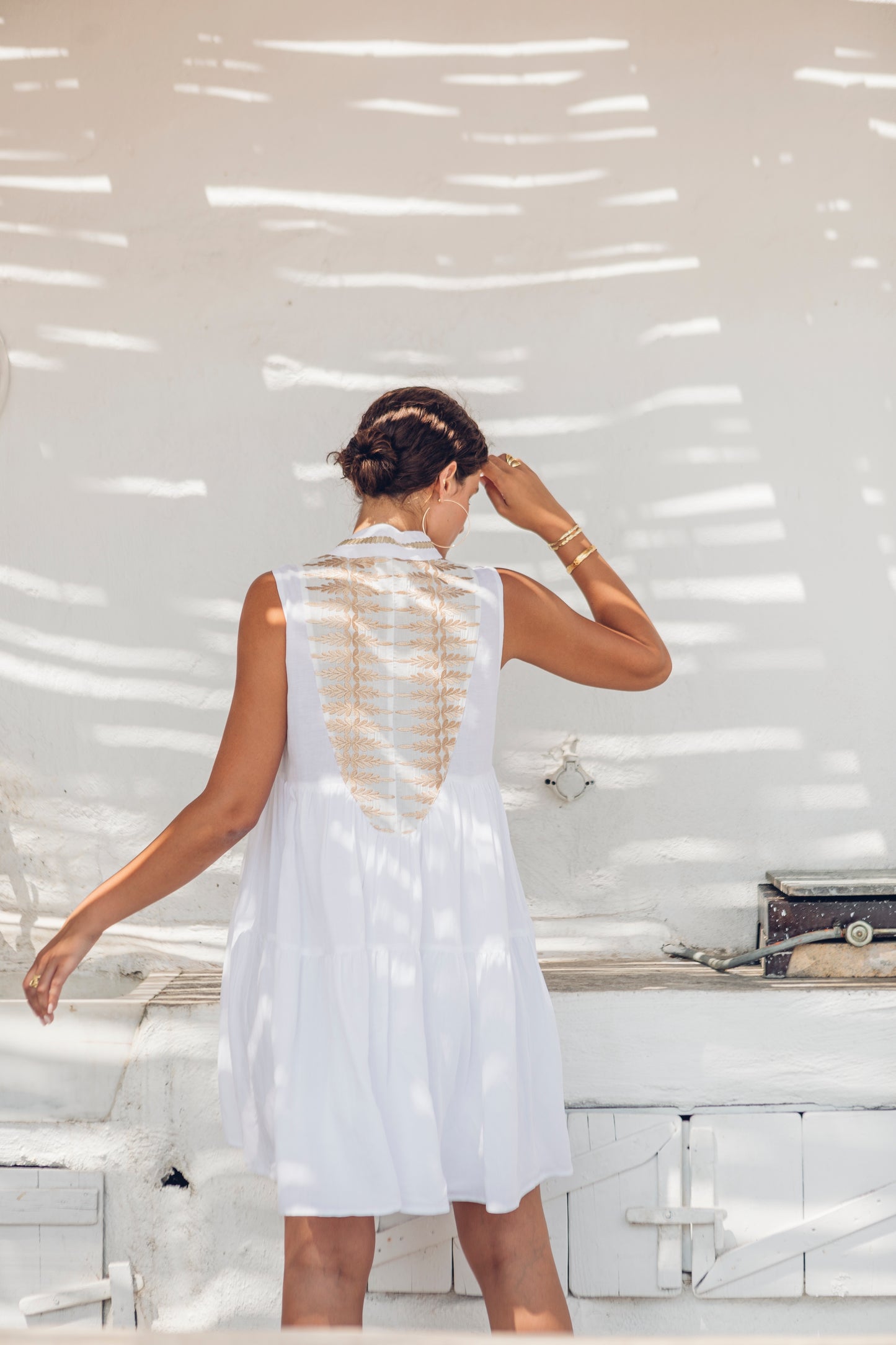 Back facing **PRE-ORDER 1st APRIL** Nema Dafne White Sleeveless Dress With Gold Embroidery. The perfection addition to your luxury designer resort wear wardrobe.