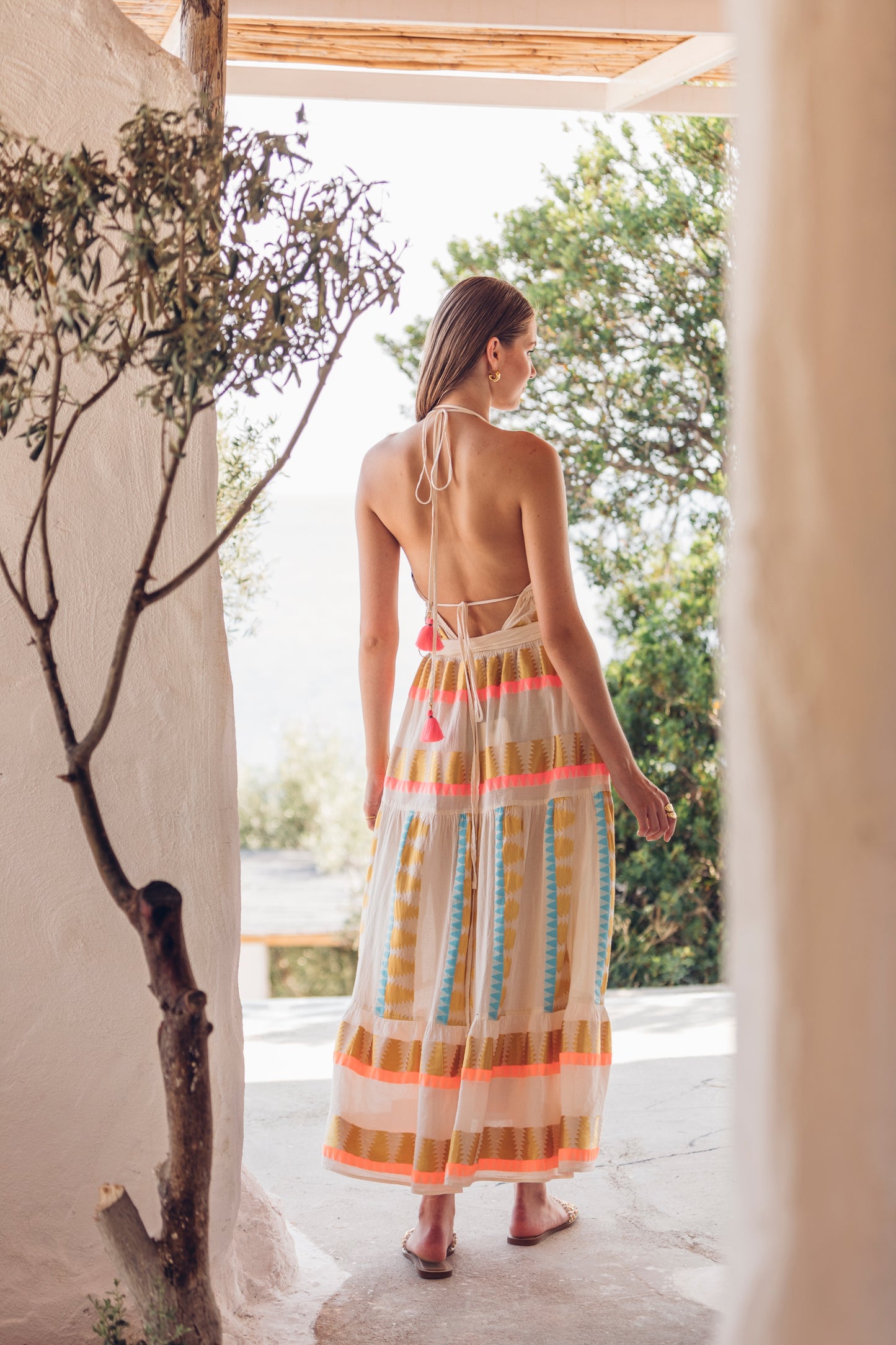 Back facing **PRE-ORDER 1st APRIL** Nema Karen Embroidered Backless Halter Neck Dress. The perfect addition to your luxury designer resort wear wardrobe.
