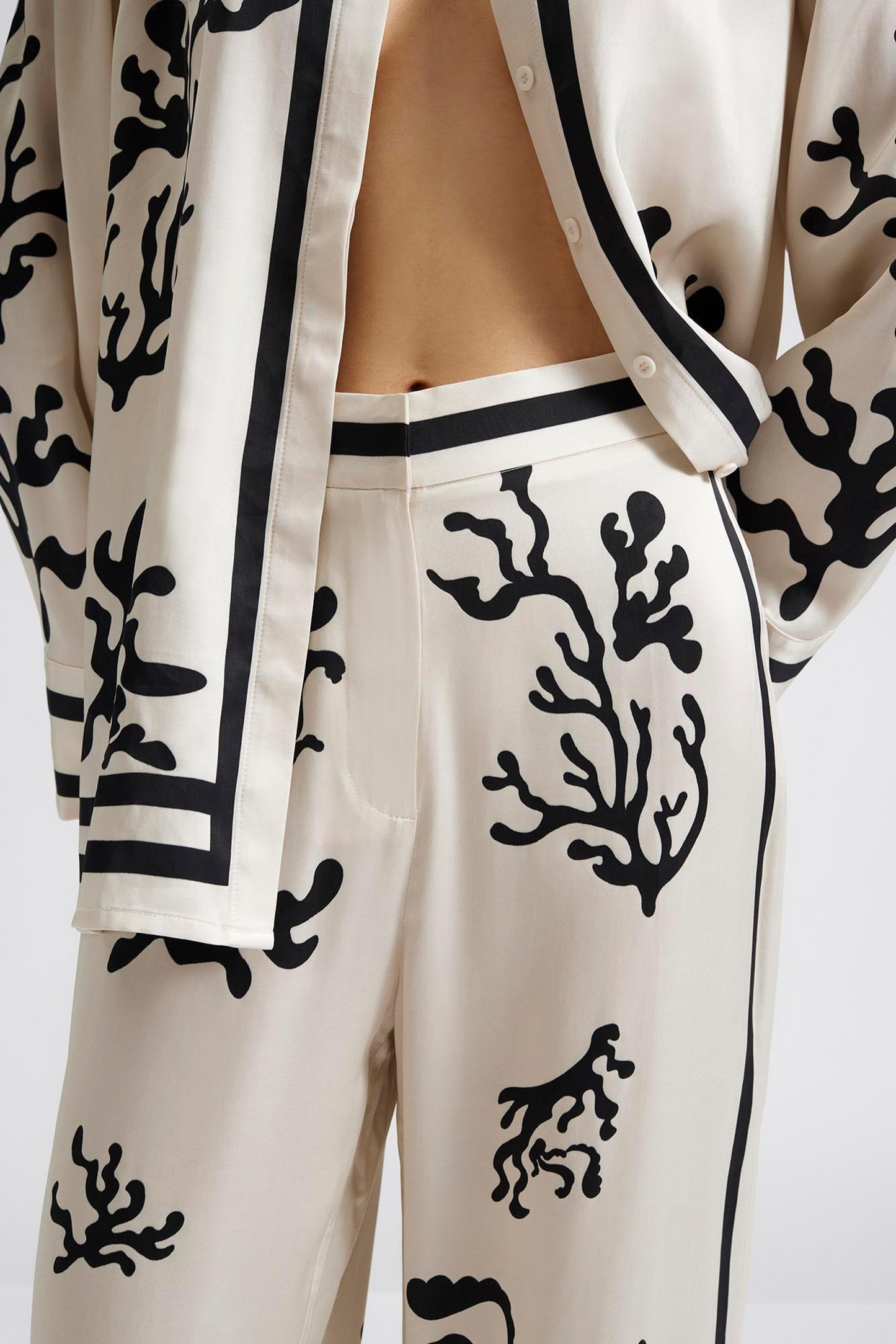 Close up Malina Cream and black printed palazzo pants in a wide fit. The perfection addition to your luxury designer resort wear wardrobe.