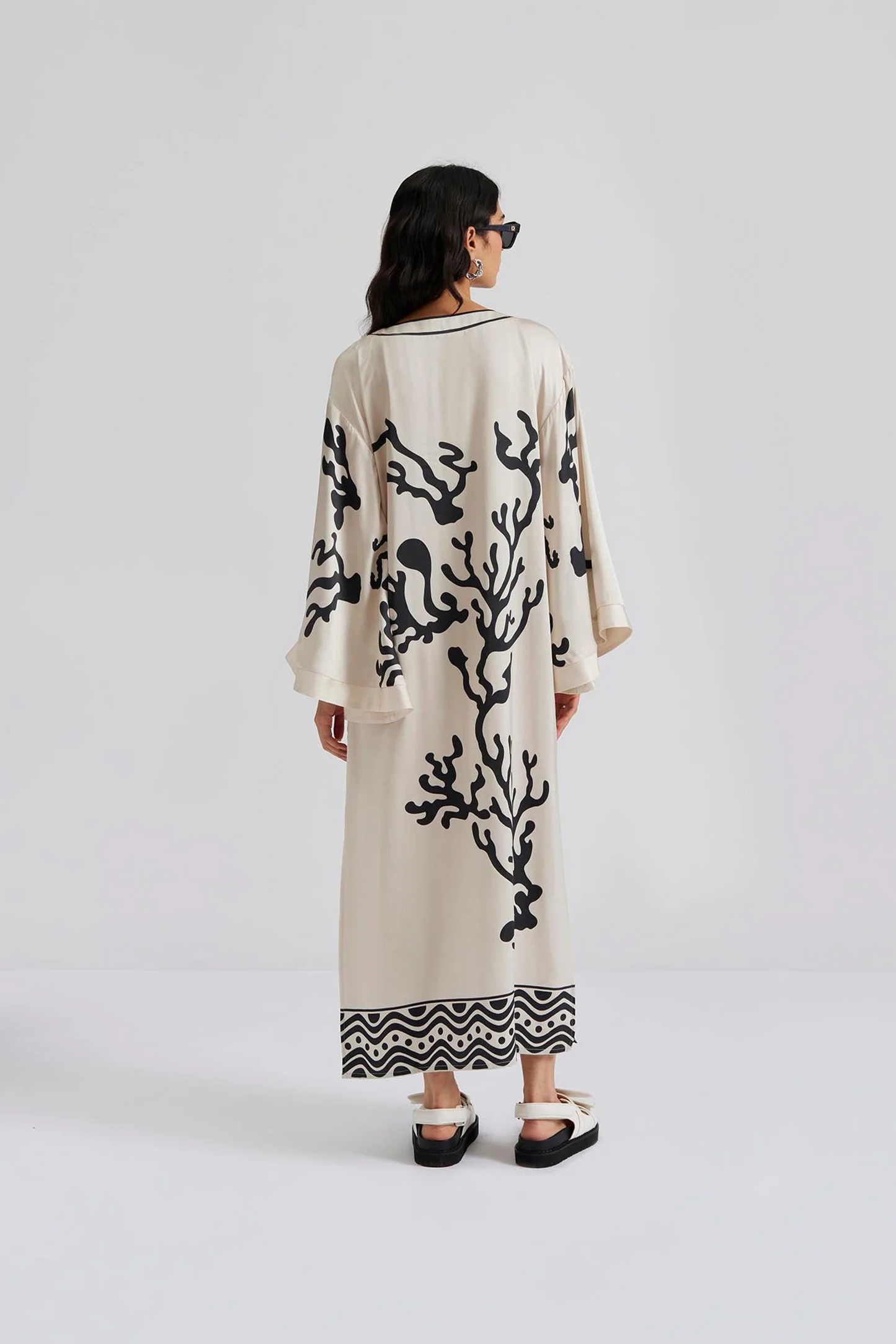 Back facing Malina Printed satin kaftan dress with wide sleeve and cut-out details. The perfect addition to your luxury designer resort wear wardrobe.