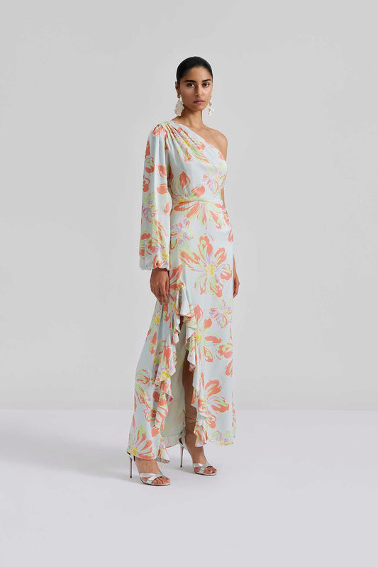 Front facing Malina Printed one shoulder long sleeved maxi dress with ruffle details and slit in the side. Effortlessly elegant and stylish, the Joslin One Shoulder Maxi Dress in Blue Lily is a must-have for any formal occasion. This one-shoulder design features flowy maxi skirt, creating a timeless and sophisticated look. Made with high-quality materials, this dress is both comfortable and chic. The perfection addition to your luxury designer resort wear wardrobe.