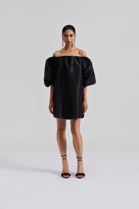 Front facing Malina Off-shoulder black mini dress with short pouf sleeve and wide fit. The perfect addition to your luxury designer resort wear wardrobe.
