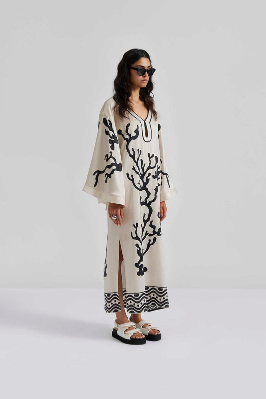 Front facing Malina Printed satin kaftan dress with wide sleeve and cut-out details. The perfect addition to your luxury designer resort wear wardrobe.