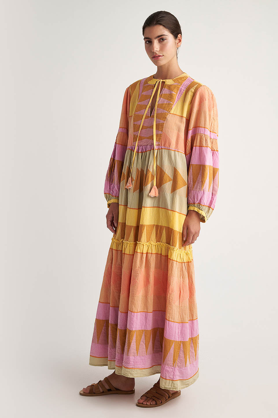 Side facing Pearl & Caviar Long sleeve pastel maxi dress with side pockets and Neck tie.The perfection addition to your luxury designer resort wear wardrobe.