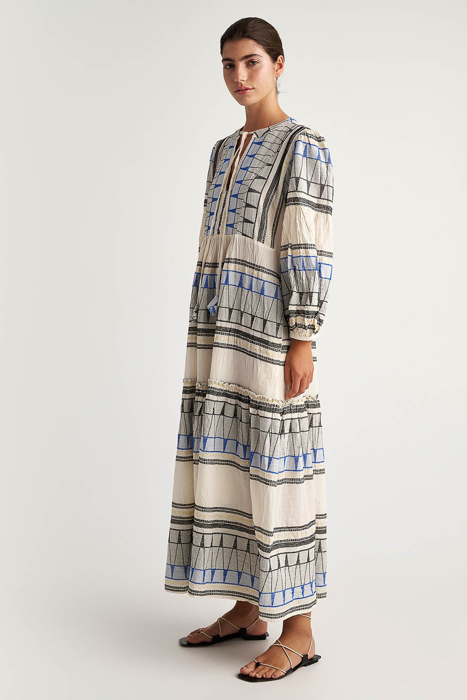 Side facing Pearl & Caviar Long sleeve maxi dress with embroidered detailing. The perfection addition to your luxury designer resort wear wardrobe.