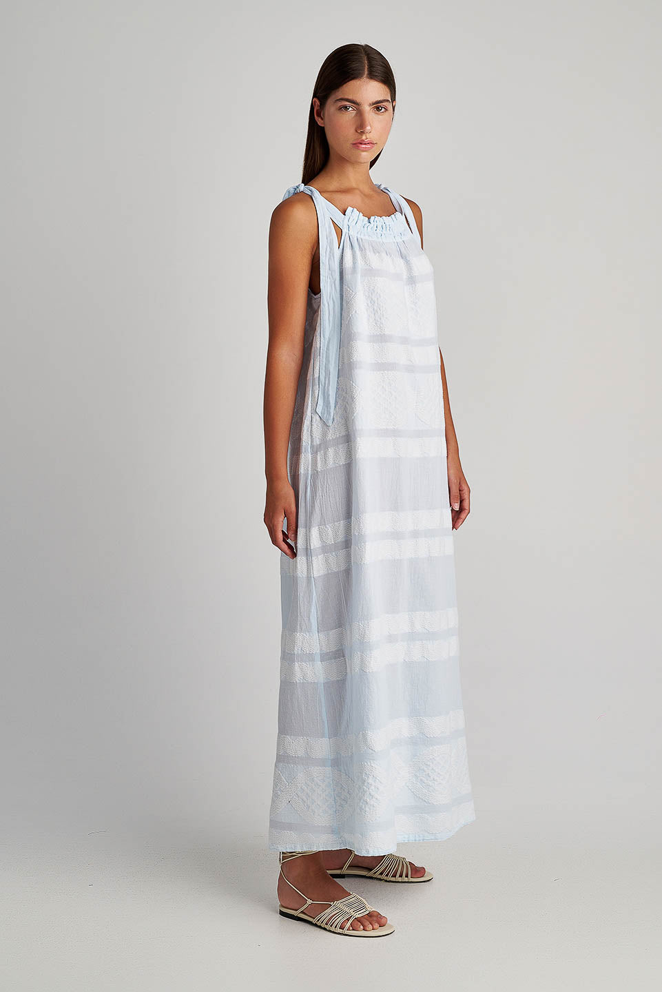 Side facing Pearl & Caviar Tie shoulder strap baby blue maxi dress with textured fabric.The perfection addition to your luxury designer resort wear wardrobe.