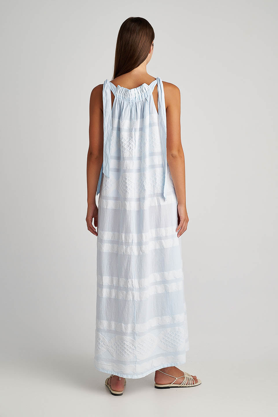 Back facing Pearl & Caviar Tie shoulder strap baby blue maxi dress with textured fabric.The perfection addition to your luxury designer resort wear wardrobe.