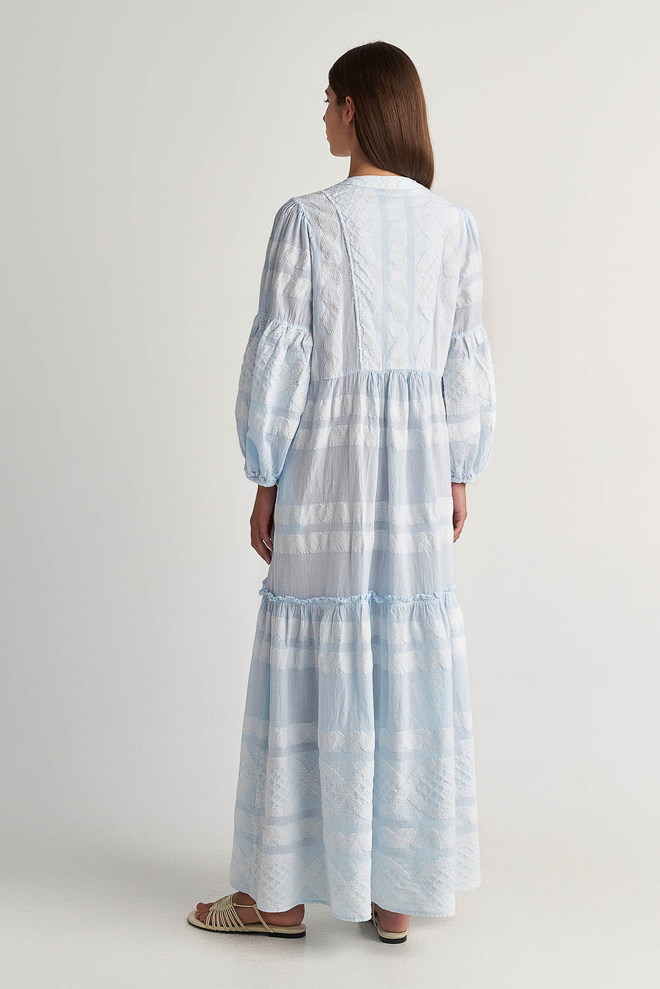 Back image Pearl & Caviar Long sleeve baby blue maxi dress with textured pattern. The perfection addition to your luxury designer resort wear wardrobe.