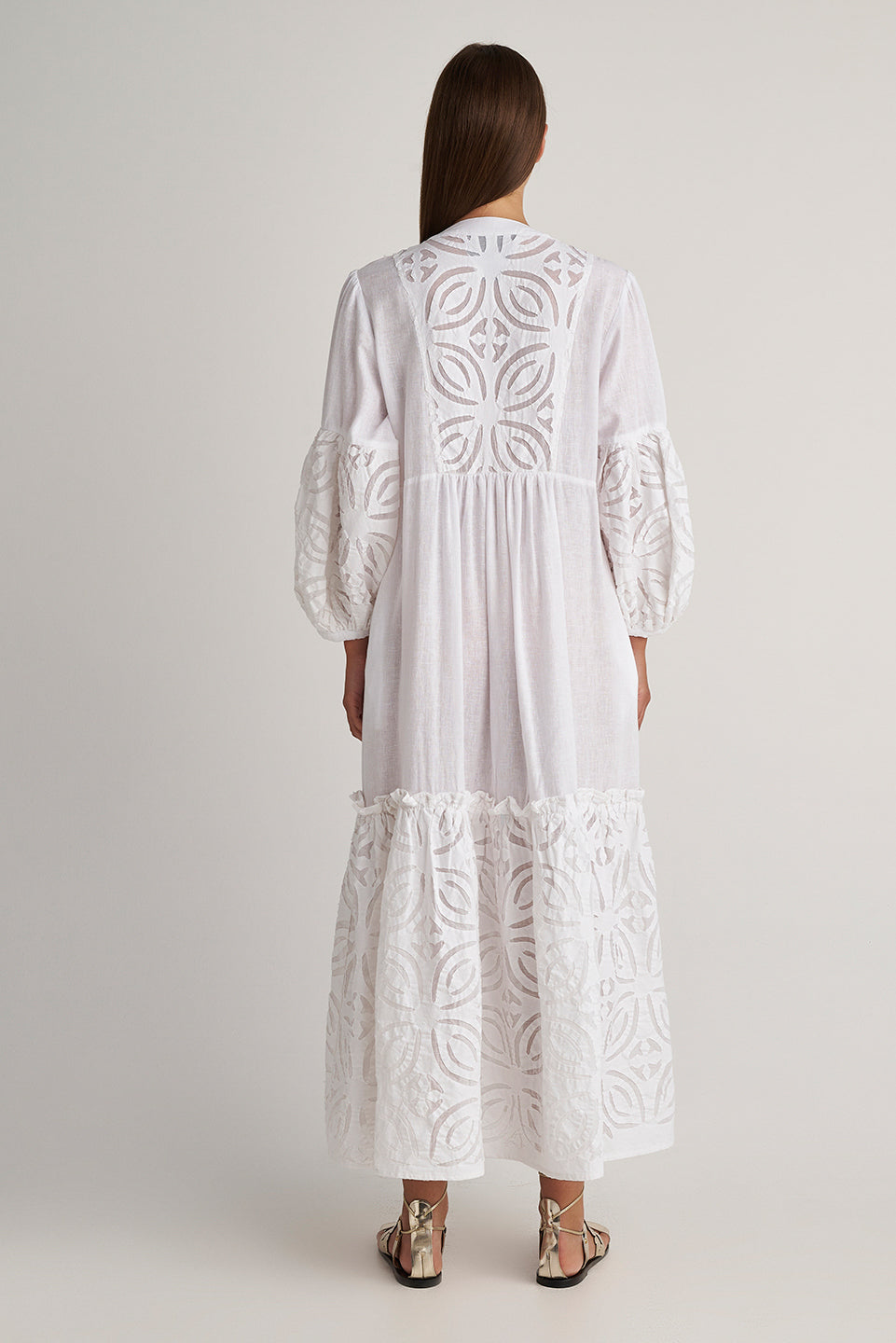 Back facing Pearl & Caviar Long sleeve pure white maxi dress with layered cut-out detailing. The perfect addition to your luxury designer resort wear wardrobe.