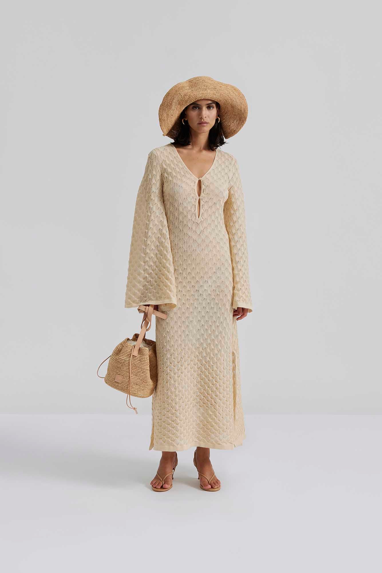 Front facing 1 Malina Knitted kaftan in maxi length with wide sleeves and cut-out neckline details. The perfect addition to your luxury designer resort wear wardrobe.