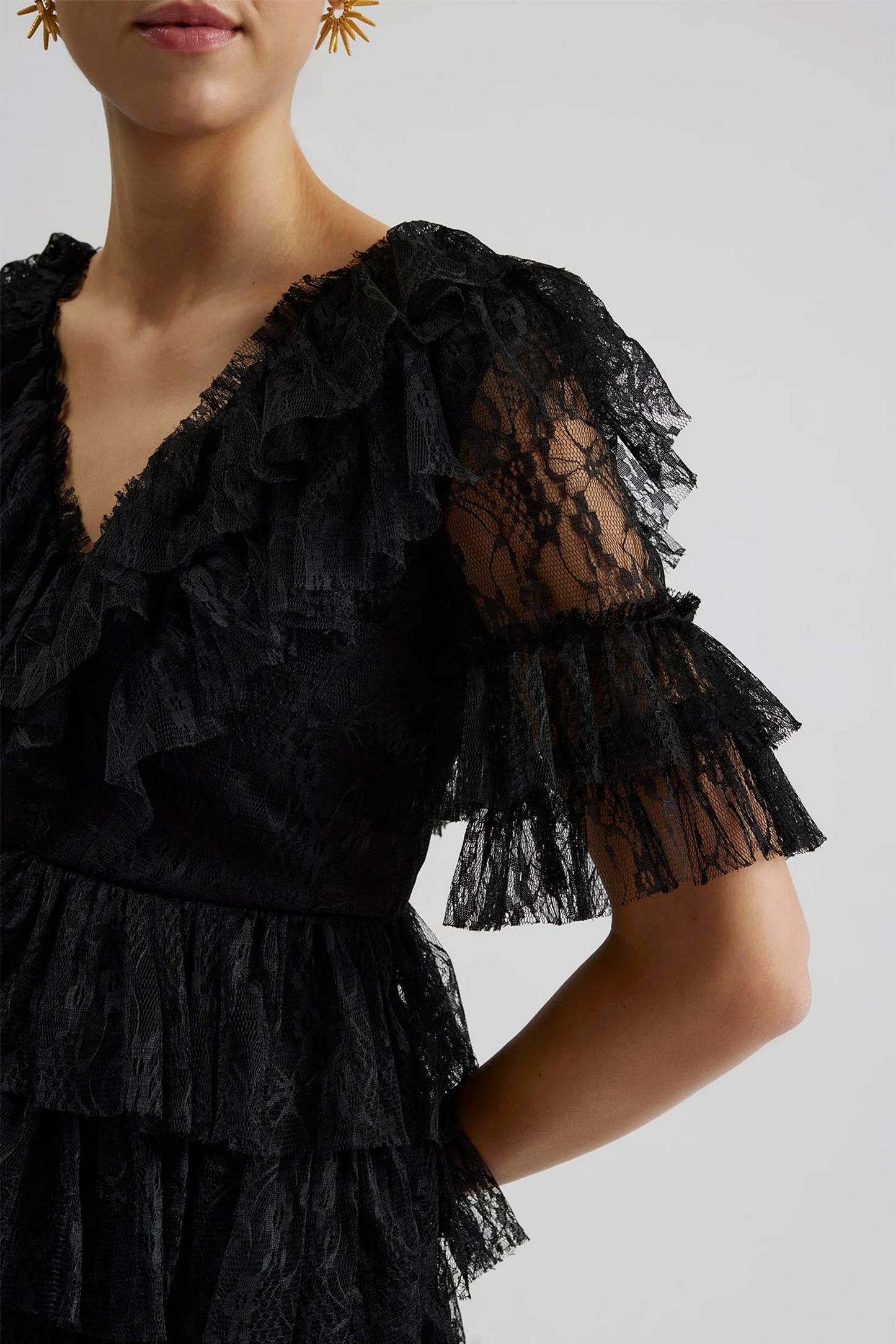 Side sleeve Malina Ready-to-Wear short sleeved lace dress with frill details and v-neck. The perfect addition to your luxury designer resort wear wardrobe.