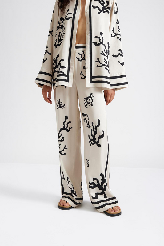 Close up 3 Malina Cream and black printed palazzo pants in a wide fit. The perfection addition to your luxury designer resort wear wardrobe.