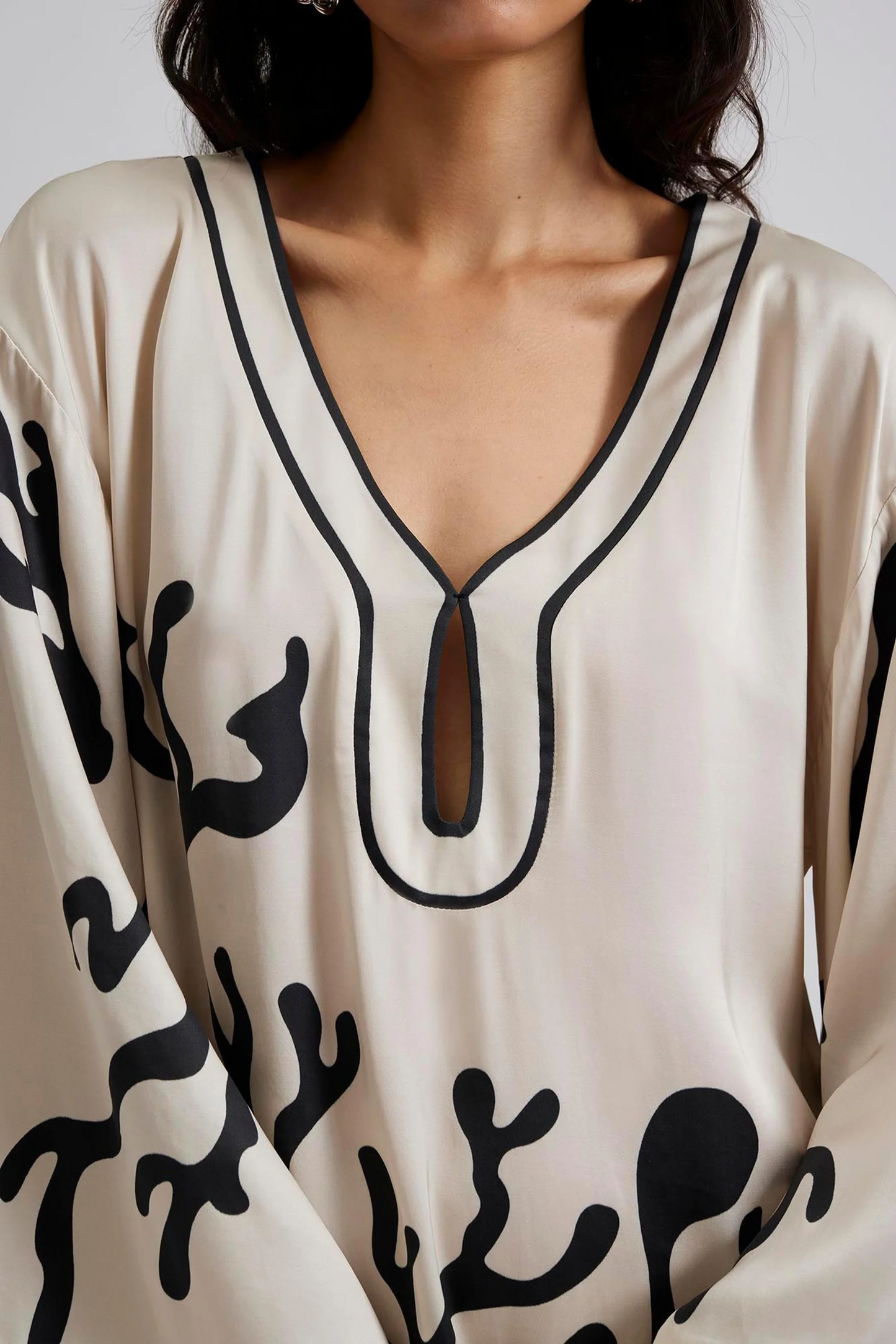Close up Malina Printed satin kaftan dress with wide sleeve and cut-out details. The perfect addition to your luxury designer resort wear wardrobe.