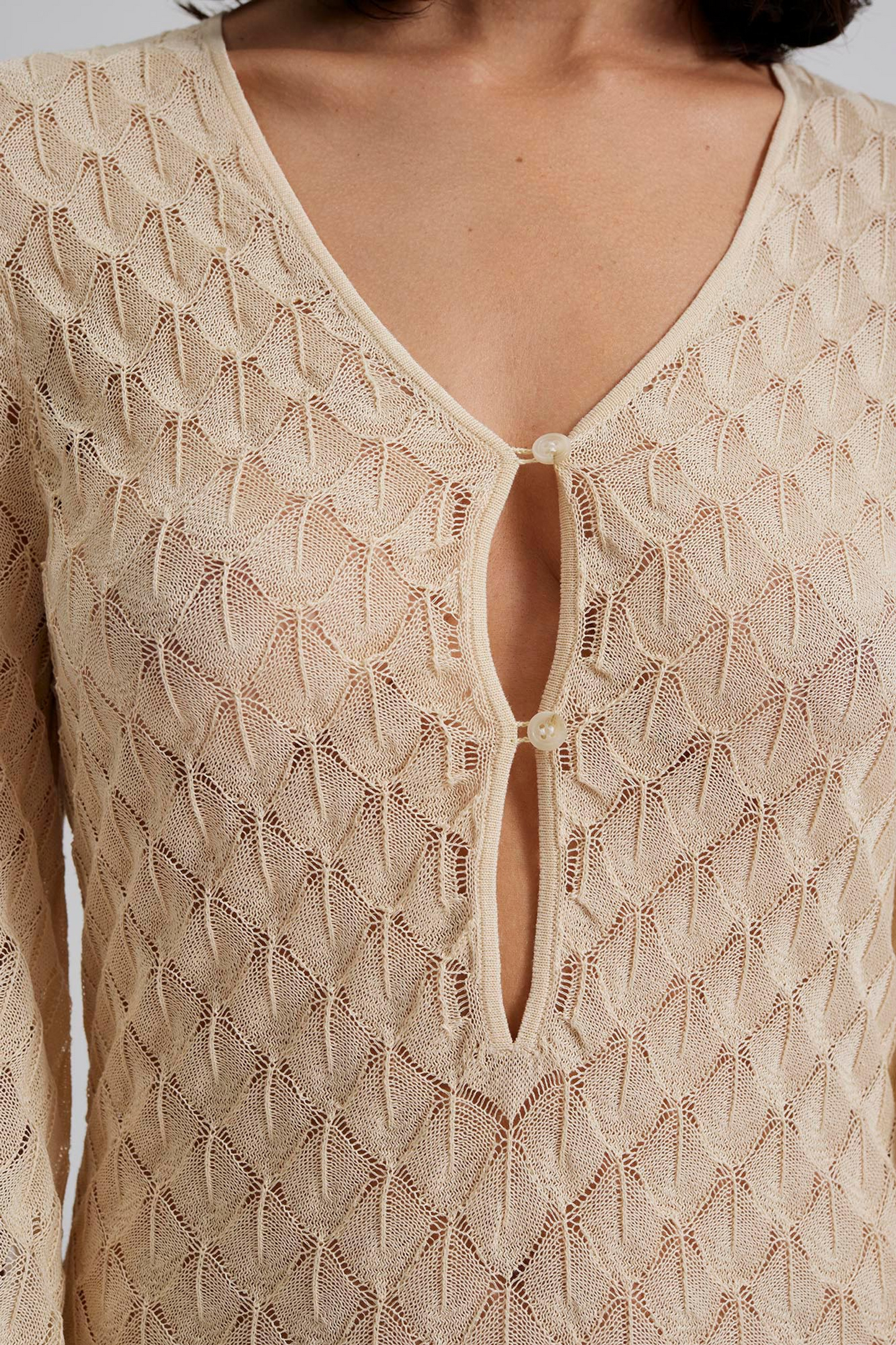 Close up Malina Knitted kaftan in maxi length with wide sleeves and cut-out neckline details. The perfect addition to your luxury designer resort wear wardrobe.