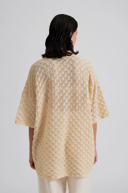 Back facing Malina Short sleeve crocheted shirt with buttons in the front. The perfect addition to your luxury designer resort wear wardrobe.  