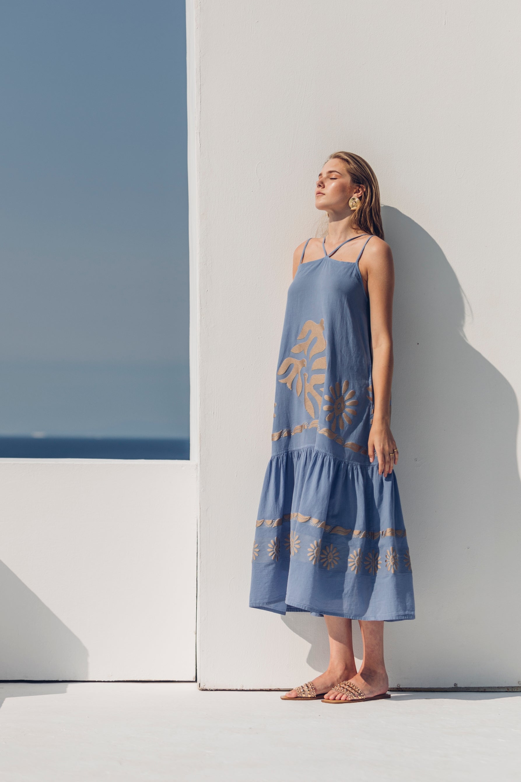 Side facing **PRE-ORDER 1st APRIL** Nema Kalia Embroidered Ciel Maxi Dress. The perfect addition to your luxury designer resort wear wardrobe. 