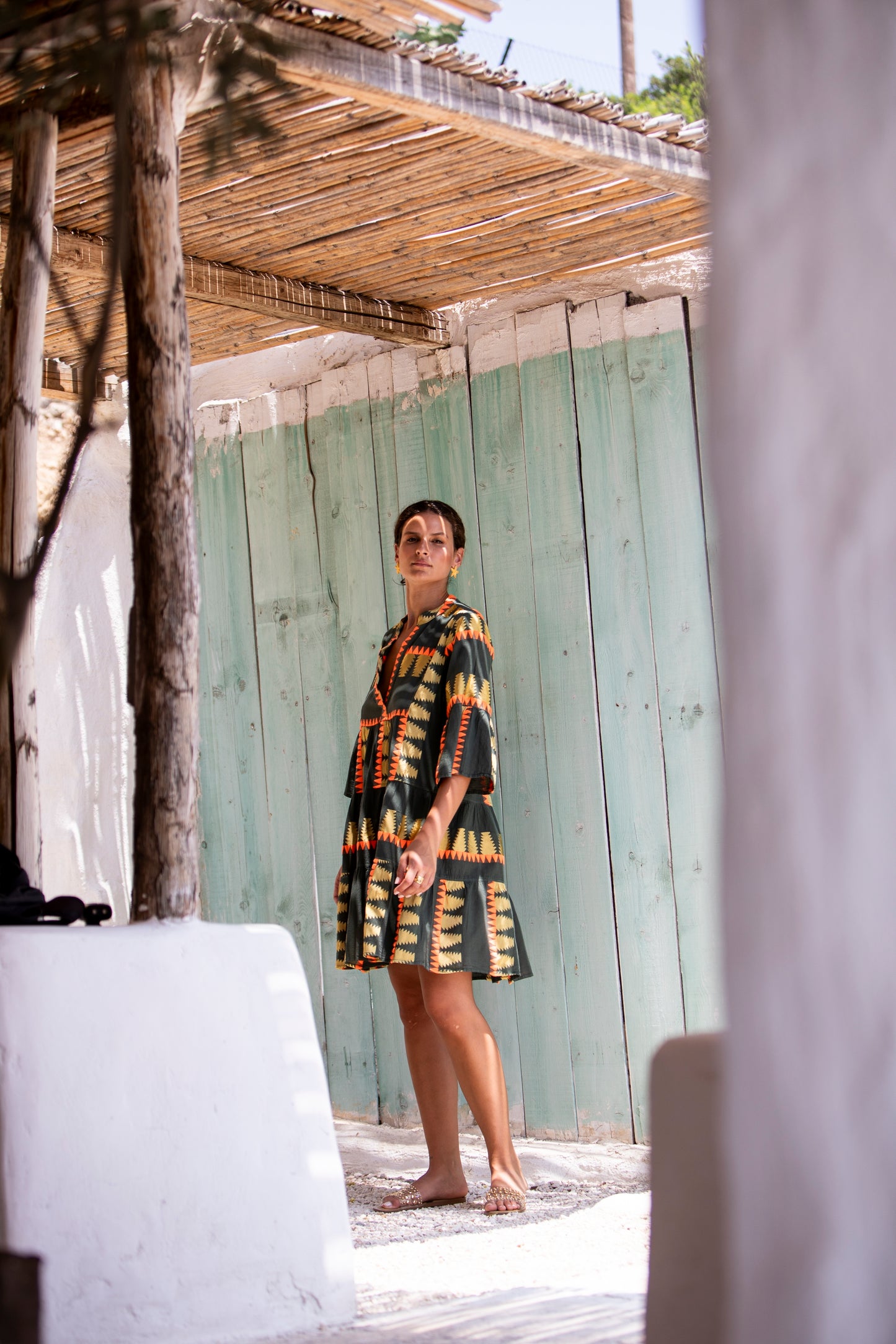 Side facing 3 **PRE-ORDER 1st APRIL** Nema Zadie Embroidered Aztec Khaki Dress. The perfect addition to your luxury designer resort wear wardrobe.  Made in Greece. 