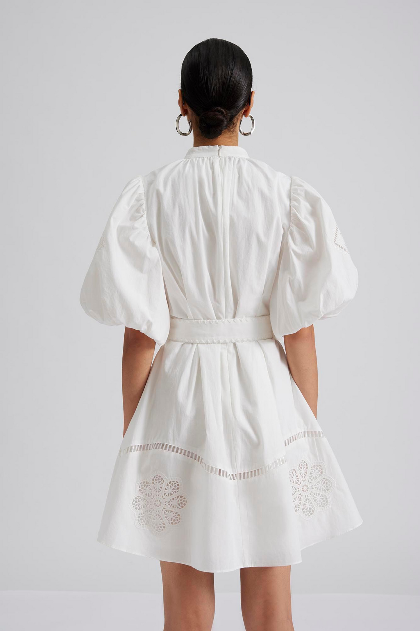 Back facing Pouf sleeve mini dress with embroidered details, belt in the waist and crochet covered buttons