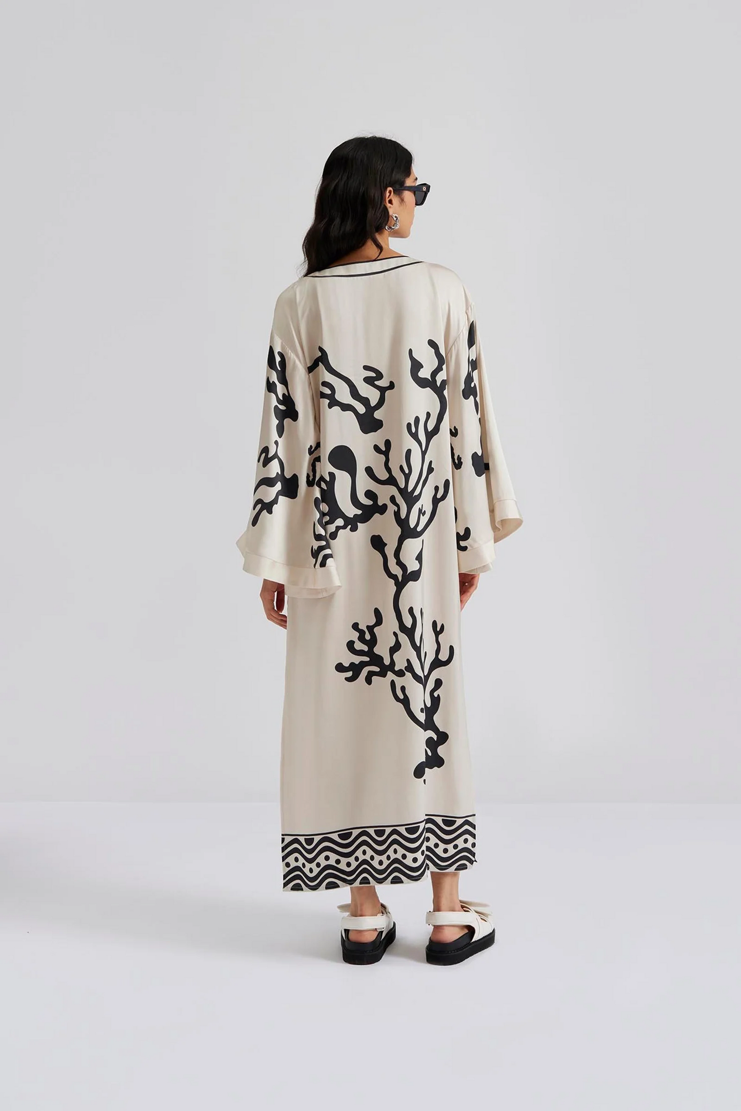 Back facing Malina Printed satin kaftan dress with wide sleeve and cut-out details. The perfect addition to your luxury designer resort wear wardrobe.  