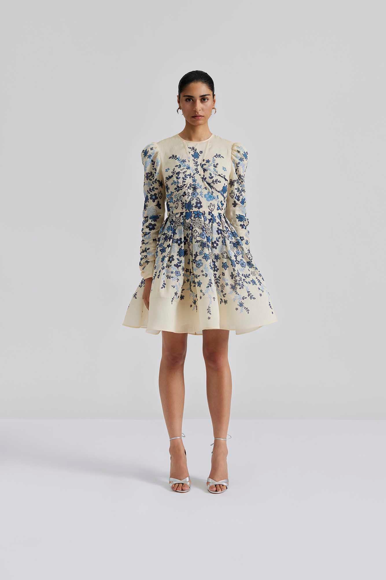 Front facing Malina Printed mini dress with long sleeve in silk blend. Expertly crafted from a luxurious silk blend, this Leoni Mini Dress features a stunning coastal floral design. With its elegant silhouette and soft, breathable fabric, this dress is perfect for any occasion. The perfect addition to your luxury designer resort wear wardrobe.  