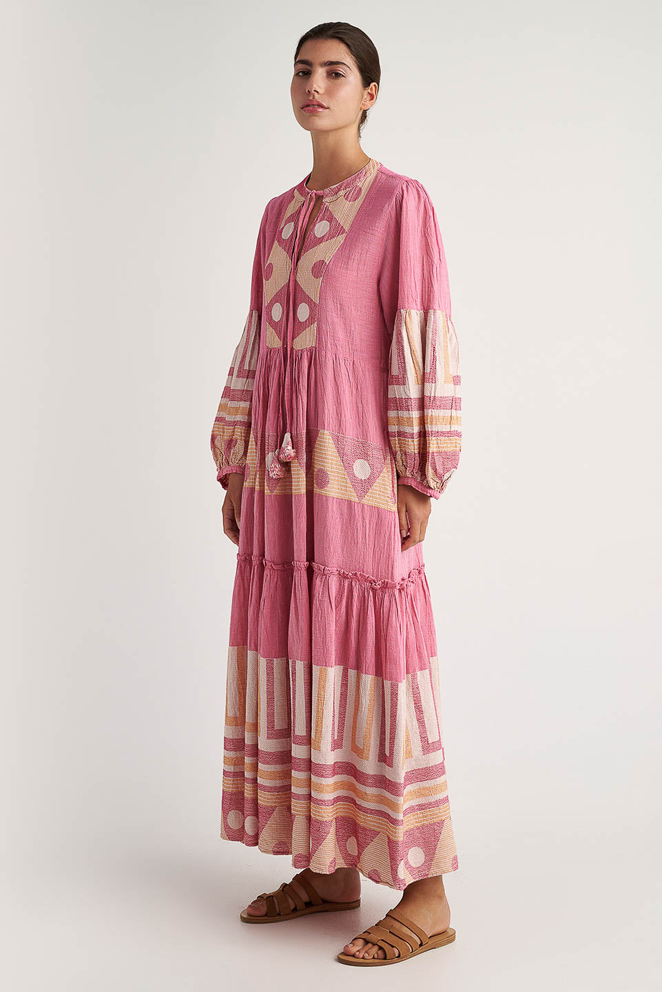 SIDE FACING Pearl & Caviar long sleeve pink maxi dress with gathered cuffs and side pockets. The perfect addition to your luxury designer resort wear wardrobe.  