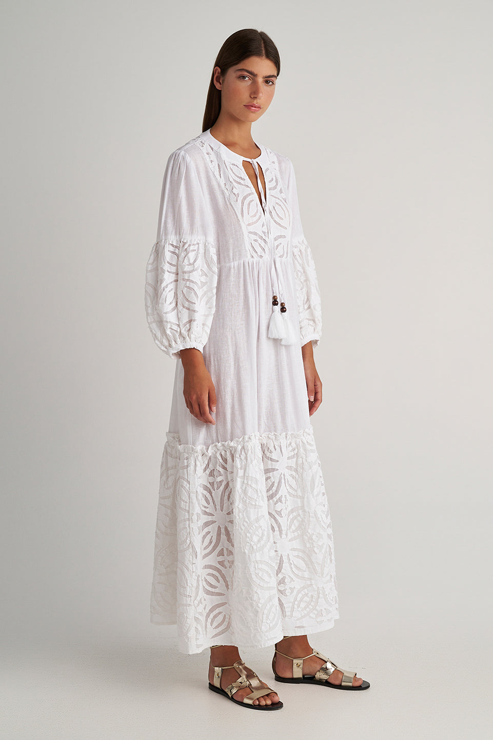 Side facing Pearl & Caviar Long sleeve pure white maxi dress with layered cut-out detailing. The perfect addition to your luxury designer resort wear wardrobe.  