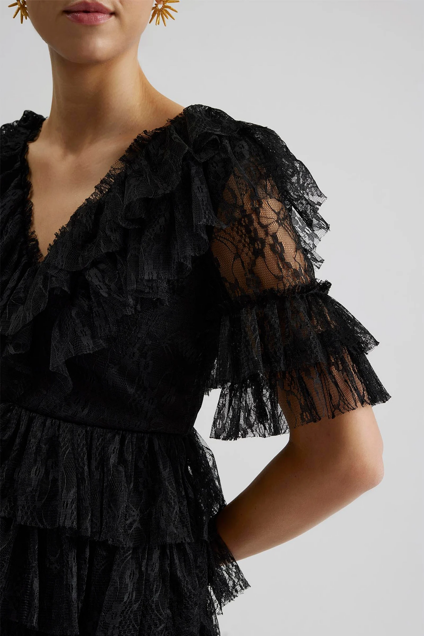 Side sleeve Malina Ready-to-Wear short sleeved lace dress with frill details and v-neck. The perfect addition to your luxury designer resort wear wardrobe.  