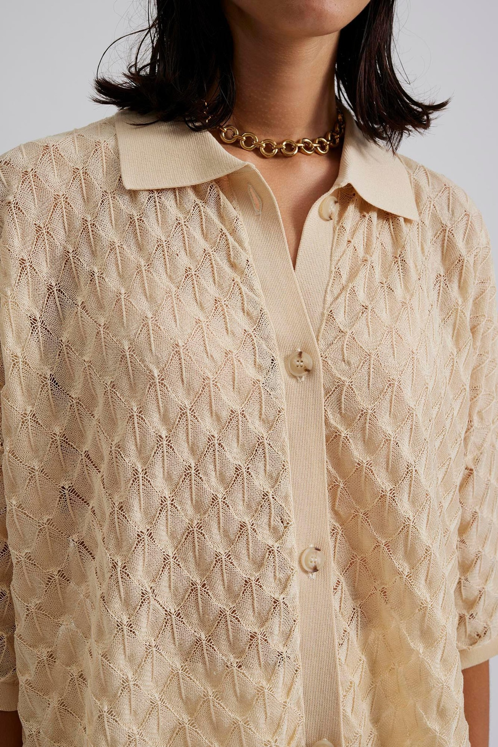 Close up 2 Malina Short sleeve crocheted shirt with buttons in the front. The perfect addition to your luxury designer resort wear wardrobe.  