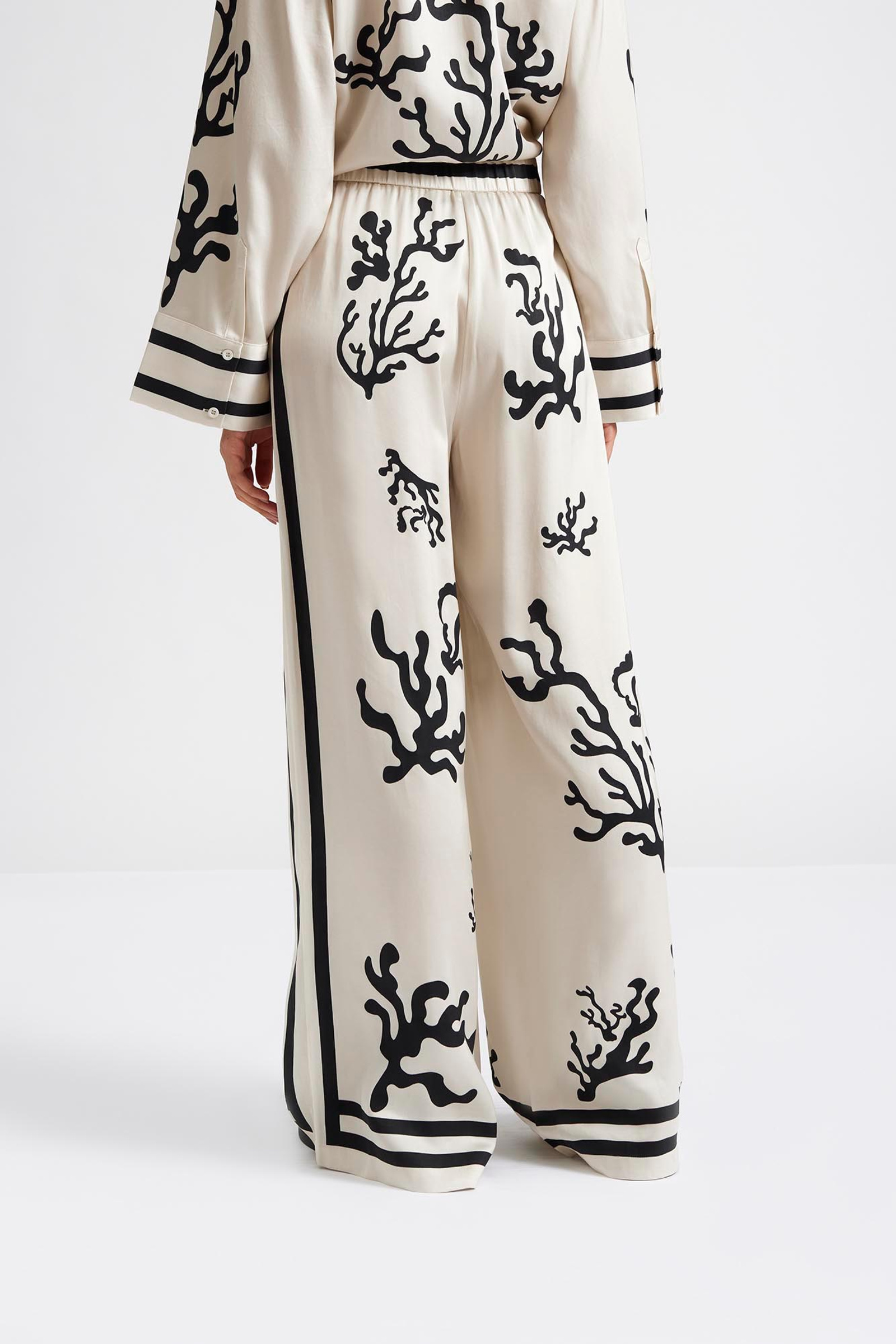 Close up 2 Malina Cream and black printed palazzo pants in a wide fit. The perfection addition to your luxury designer resort wear wardrobe. 