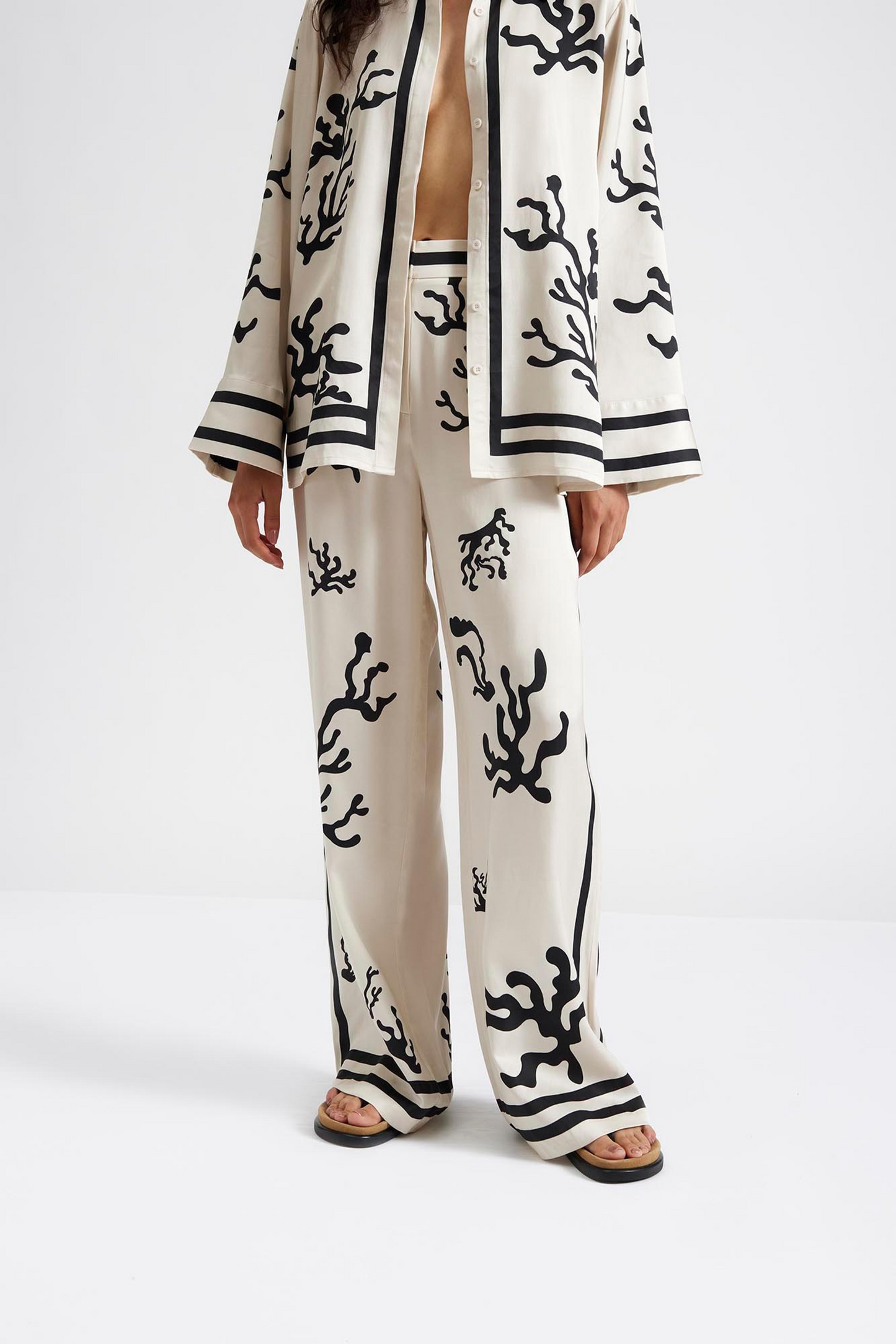 Close up 3 Malina Cream and black printed palazzo pants in a wide fit. The perfection addition to your luxury designer resort wear wardrobe. 