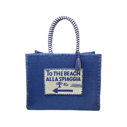 Front side beautifully hand crafted designer Navy Blue De Siena jute beach bag, with beaded detail and raffia embroidery along with a cotton lining. Perfect for your next luxury trip to paradise. Beach bag.