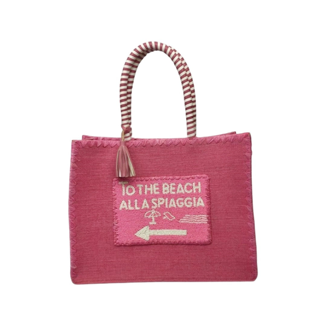 Front Side beautifully hand crafted designer Hot Pink De Siena jute beach bag, with beaded detail and raffia embroidery along with a cotton lining. Perfect for your next luxury trip to paradise.